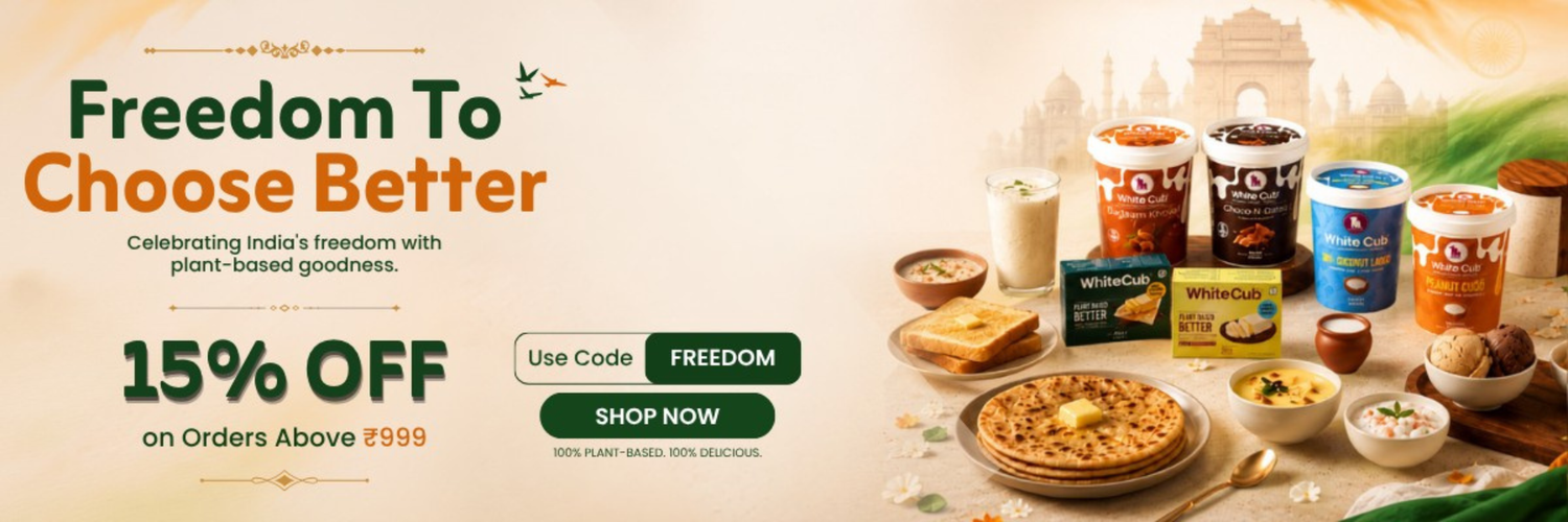 Promotional banner for a food delivery or grocery offer, featuring the headline 'Freedom To Choose Better' and '15% OFF on Orders Above ₹999'. The right side shows a styled food spread with multiple branded yogurt containers, a sandwich, a plate of food, and other snacks on a warm beige background with faint architectural silhouettes.